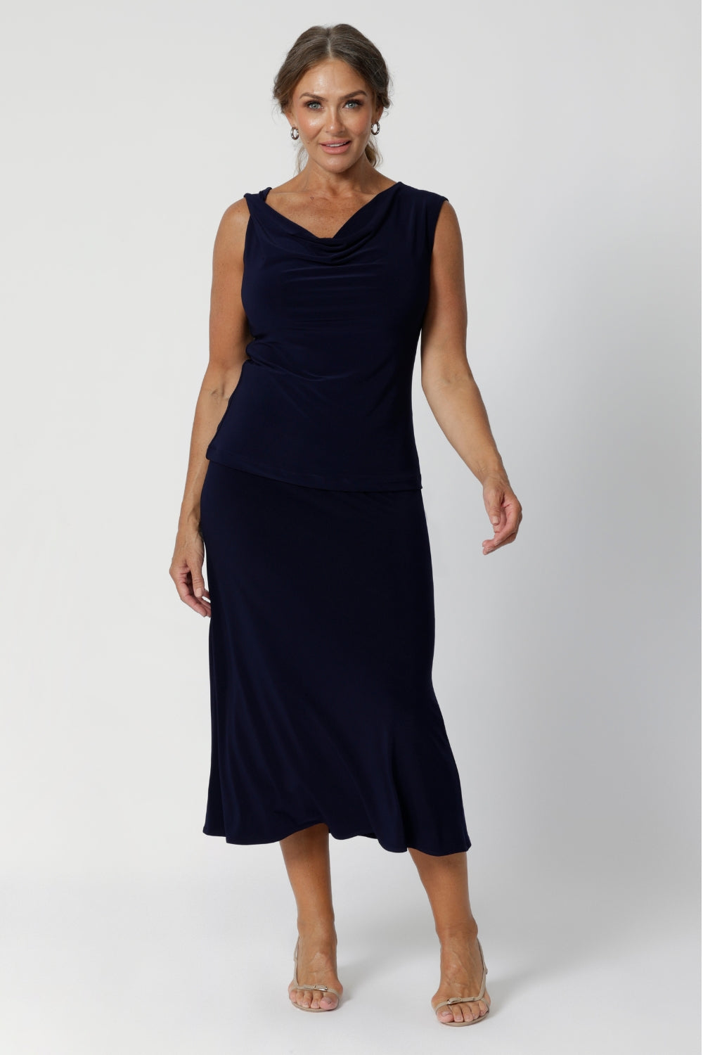 This Australian-made midi skirt is crafted from a soft-touch jersey fabric, offering a lightweight feel that's perfect for all-day comfort. Size 12 model wears travel ready skirt in deep navy colour.