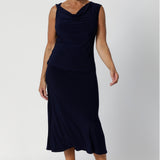 This Australian-made midi skirt is crafted from a soft-touch jersey fabric, offering a lightweight feel that's perfect for all-day comfort. Size 12 model wears travel ready skirt in deep navy colour.