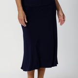 Darts at the back provide shaping, enhancing the natural contours of the body while preserving the A-line shape that gives the skirt its elegant, feminine structure. The midi length offers versatility, falling just below the knee to create a polished, refined appearance that's perfect for professional settings or travel.