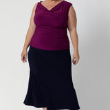 Whether you're dressing for the office or heading out on the go, this skirt serves as a reliable, stylish option that easily pairs with a range of tops, blouses, and jackets. Plus size model wears timeless design in deep blue colour. This Navy Midi Skirt is a versatile wardrobe essential—an ideal piece to keep you looking put-together and confident, wherever the day takes you. Available in size 8-24.