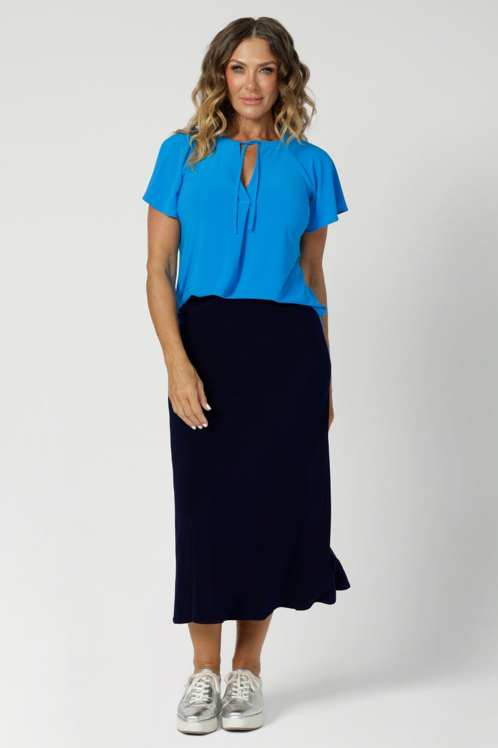 This Australian-made midi skirt is crafted from a soft-touch jersey fabric, offering a lightweight feel that's perfect for all-day comfort. Size 12 model wears travel ready skirt in deep navy colour.