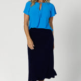 This Australian-made midi skirt is crafted from a soft-touch jersey fabric, offering a lightweight feel that's perfect for all-day comfort. Size 12 model wears travel ready skirt in deep navy colour.