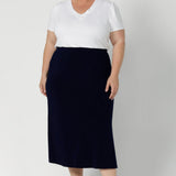 Whether you're dressing for the office or heading out on the go, this skirt serves as a reliable, stylish option that easily pairs with a range of tops, blouses, and jackets. Plus size model wears timeless design in deep blue colour. This Navy Midi Skirt is a versatile wardrobe essential—an ideal piece to keep you looking put-together and confident, wherever the day takes you. Available in size 8-24l 