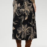 Featuring a rich, inky floral print in a warm coffee hue, it captures the mood of the season with understated elegance. The A-line silhouette is cut on the bias for fluid movement and subtle drape, while the internal elastic waistband ensures a seamless, pull-on fit.