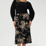 The Asher Skirt brings effortless style to your wardrobe with its easy pull-on design and soft stretch feel, crafted from our signature dry-touch jersey in classic black. Plus size model wears midi skirt with black top with bellow sleeves.