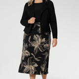 Crafted from our signature dry-touch jersey in classic black. Plus size model wears midi skirt with black top with bellow sleeves and a structured black work jacket. Creating a ready for work look.
