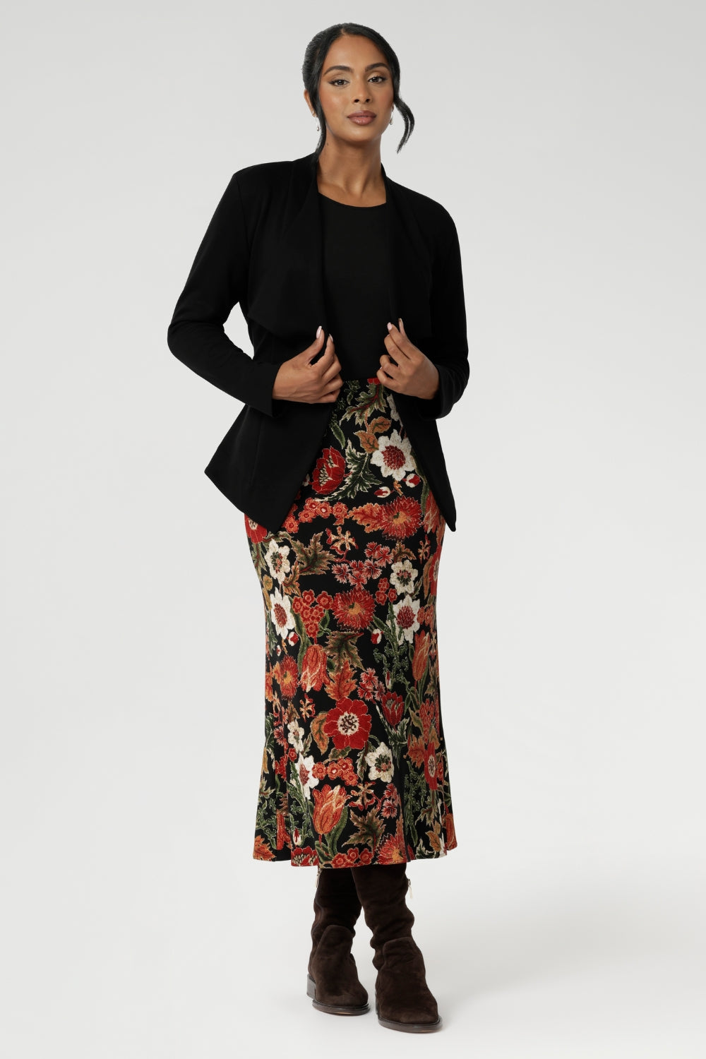 Sophisticated, versatile, and made to flatter — the Lyndon Jacket blends comfort and elegance. Size 10 model wears her Lyndon Jacket in Black with printed midi length skirt with brown long boots. Available in size 8-24.