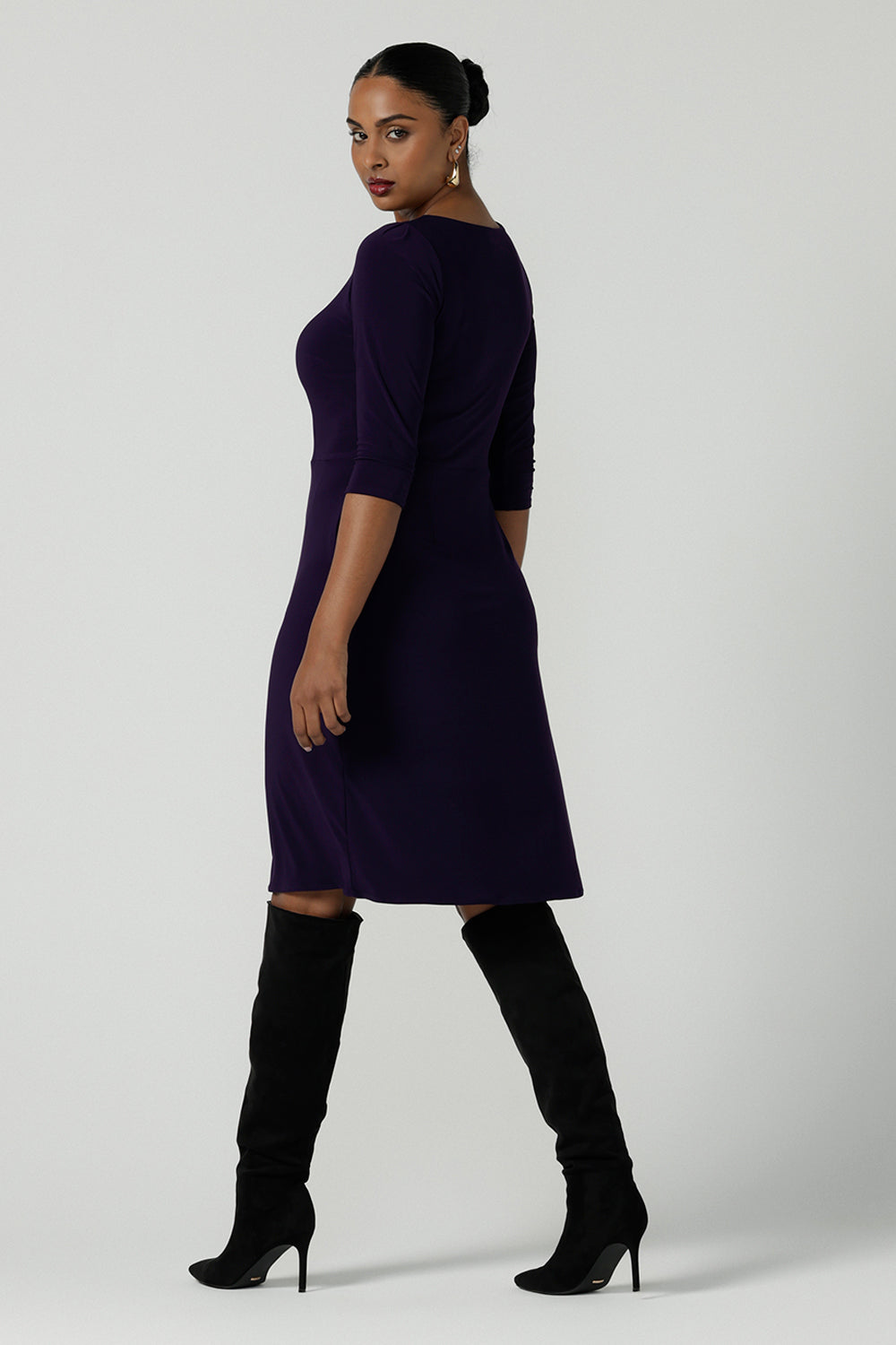 Back view of a size 10 woman wears the Audrey Dress in Amethyst. A purple Jersey dress made for women size 8-24. A comfortable workwear dress for petite to plus size 8-24.