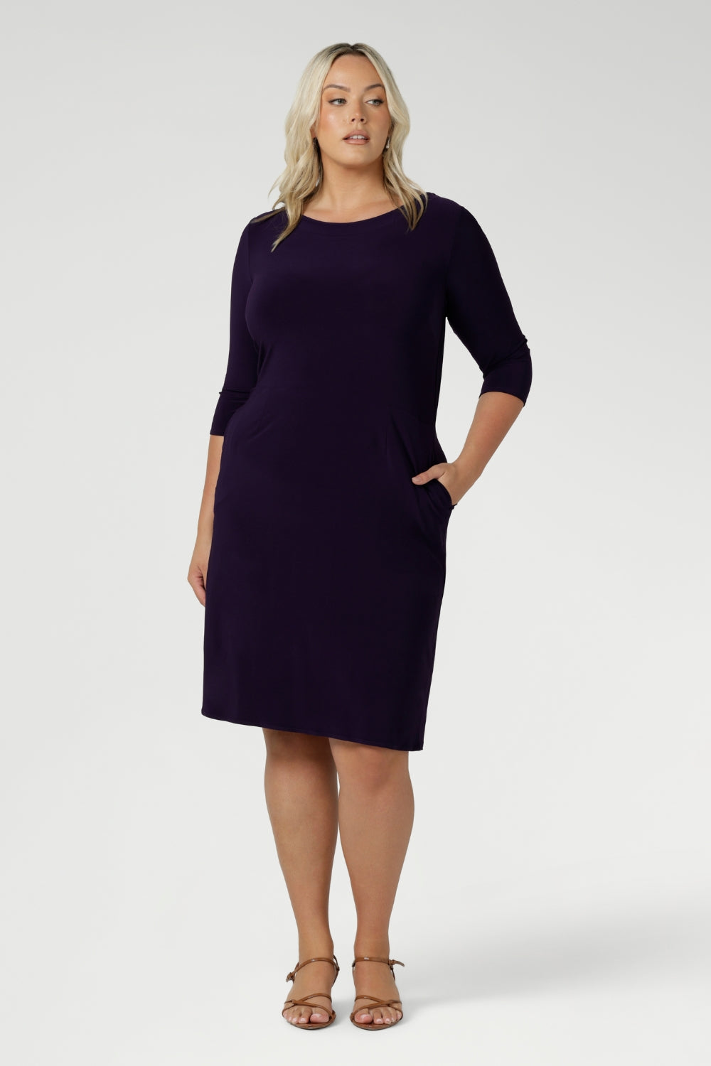 Curvy plus size women wears workwear dress with knee length skirt and scoop neckline for women in size 18. Easy care fabric is Australian made for women in Australia & New Zealand.