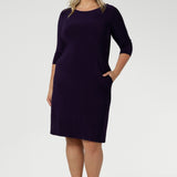 Curvy plus size women wears workwear dress with knee length skirt and scoop neckline for women in size 18. Easy care fabric is Australian made for women in Australia & New Zealand.