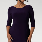 Back view of a size 10 woman wears the Audrey Dress in Amethyst. A purple Jersey dress made for women size 8-24. A comfortable workwear dress for petite to plus. Australian made in sizes 8-24.