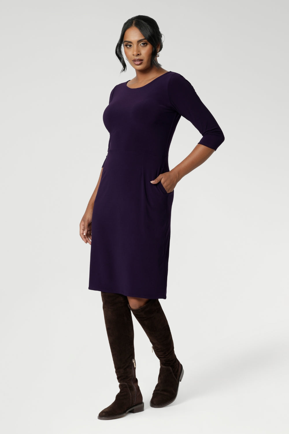 A size 10 woman wears the Audrey Dress in Amethyst. A purple Jersey dress with pockets made in Australia for women in size 8-24.