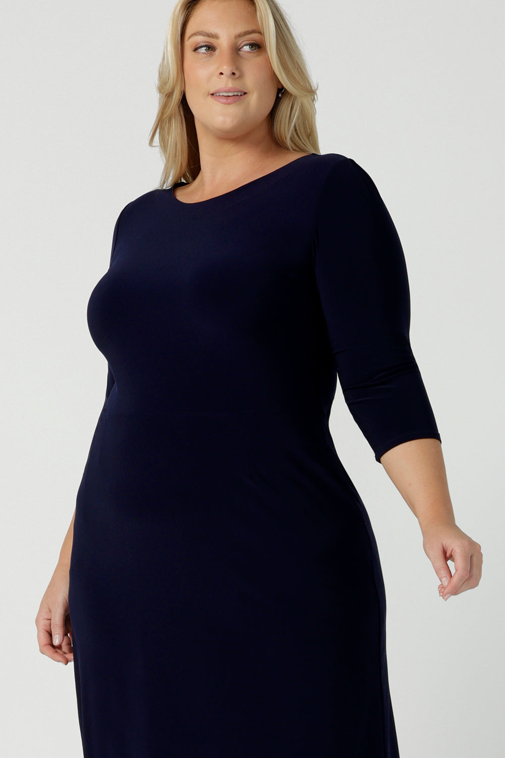 A size 18 woman wears the Audrey Shift Dress in Navy is the perfect all season shift dress. Soft jersey fabric, 3/4 sleeves and pockets. Made in Australia for women size 8 - 24.