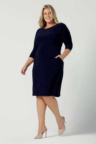 A size 18 woman wears the Audrey Shift Dress in Navy is the perfect all season shift dress. Soft jersey fabric, 3/4 sleeves and pockets. Made in Australia for women size 8 - 24. 