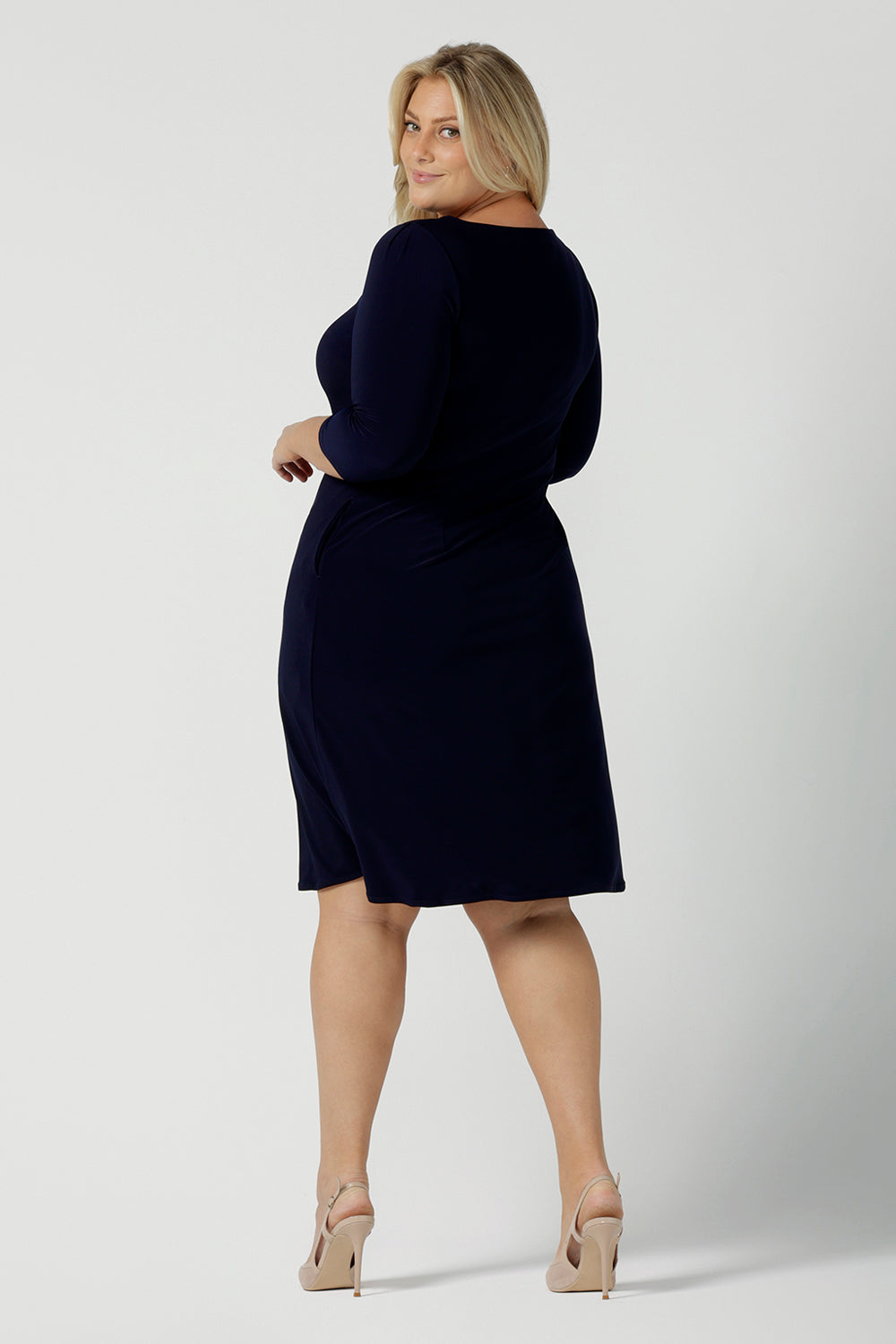 Back view of a size 18 woman wears the Audrey Shift Dress in Navy is the perfect all season shift dress. Soft jersey fabric, 3/4 sleeves and pockets. Made in Australia for women size 8 - 24.