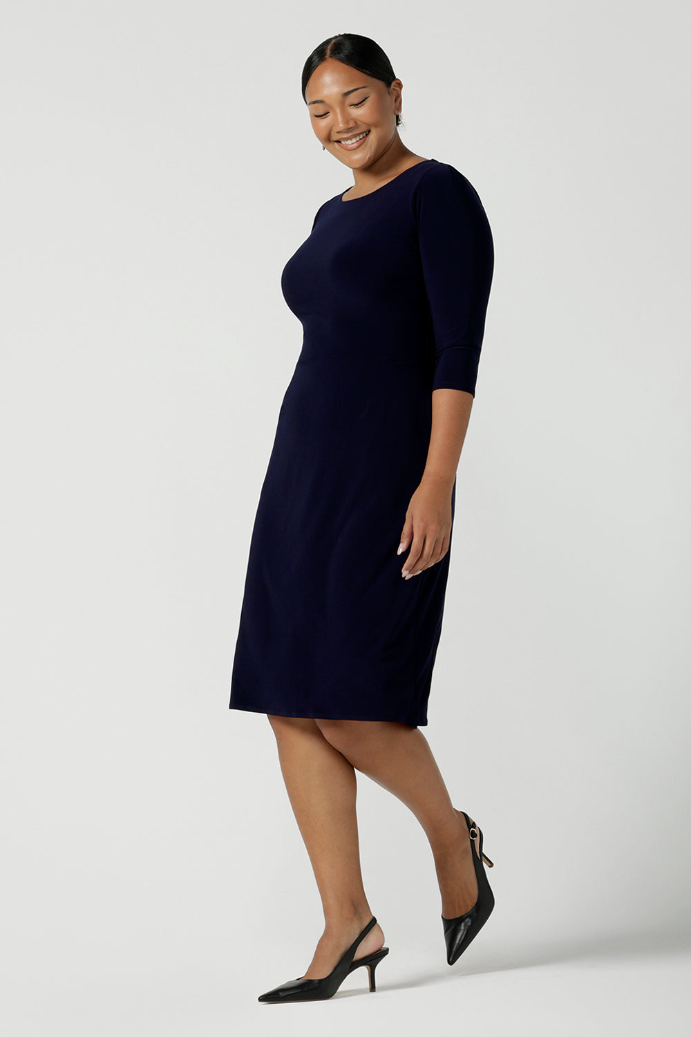 A size 10 woman wears the Audrey Shift Dress in Navy is the perfect all season shift dress. Soft jersey fabric, 3/4 sleeves and pockets. Made in Australia for women size 8 - 24.