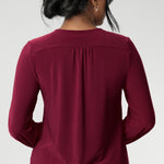 The semi-fitted silhouette features long bell sleeves with cuffs that add a touch of drama, while still maintaining a polished, versatile look. The curved shirt-tail hemline flatters the hips when worn loose and maintains a chic, modern vibe if you prefer to French tuck. Available in inclusive sizes 8 to 24