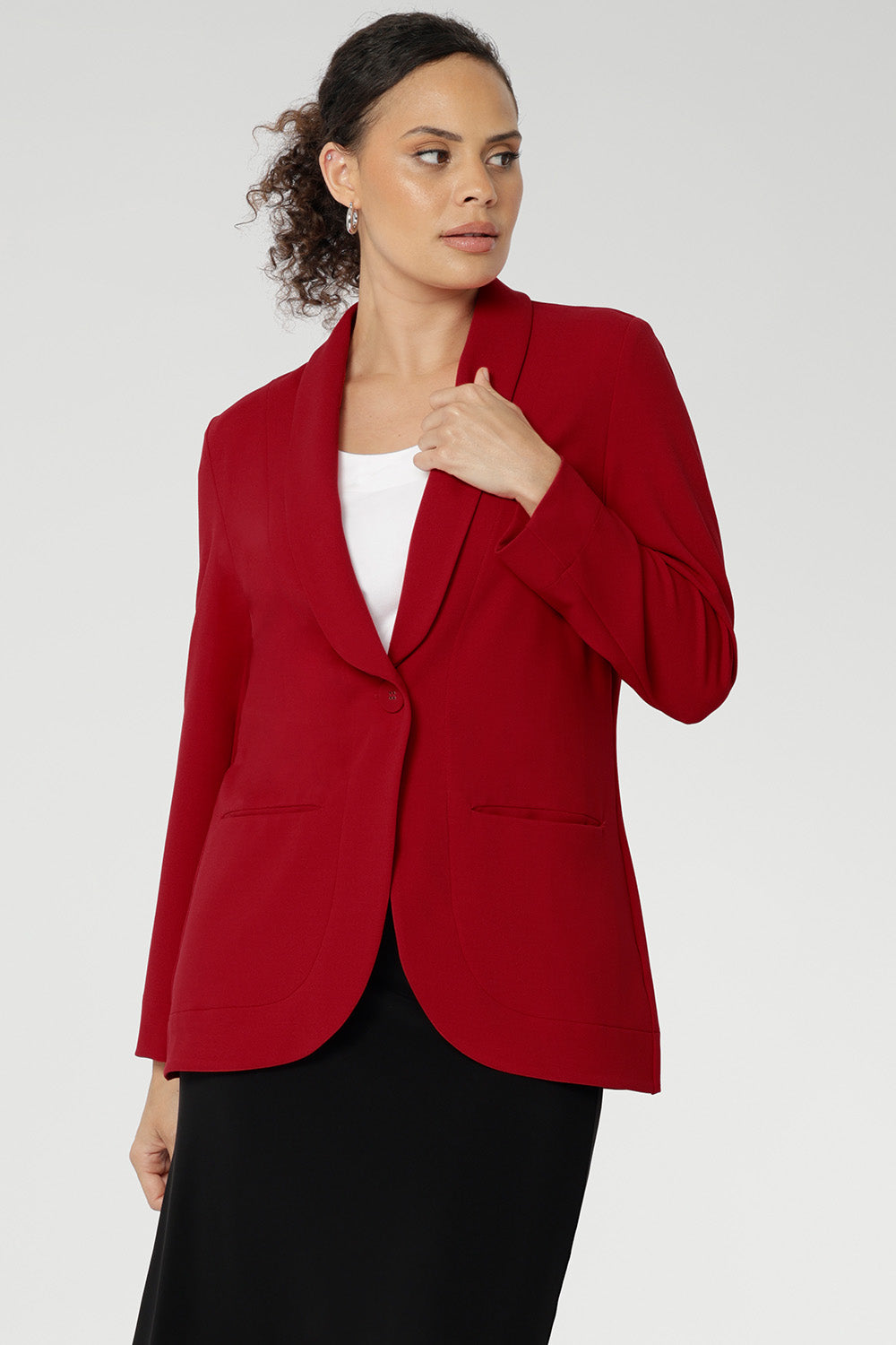 Bright red coloured blazer, a textured scuba crepe  This red work blazer is worn with red workwear pants and navy work top. Curved hemline and front pockets. This blazer is Made in Australia for petite women in sizes 8 - 24.