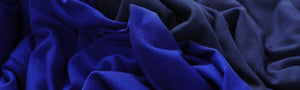 Cobalt blue and French navy bamboo jersey fabrics swirled together to show the qualities of the bamboo fabric used by Australian fashion brand, Leina & Fleur to make a range of lightweight, breathable tops for women. 