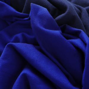 Cobalt blue and French navy bamboo jersey fabrics swirled together to show the properties of the bamboo jersey fabric used by Australia women's clothing brand, Leina & Fleur to make a range of lightweight tops for women.