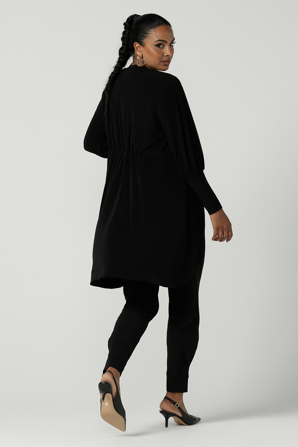 Back view of a size 10 woman wearing the Bardon Duster in Black, a jersey cardigan with balloon sleeves and made in comfortable jersey. Petite to plus size and styled back with the Bardon Duster in Black. And amethyst top.