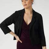Crafted from Black Scuba Crepe Jersey, this fabric combines a soft stretch with a luxurious feel, ensuring both comfort and structure throughout the day. The open-front design creates a sleek, modern look, making it easy to layer over both formal and casual outfits.