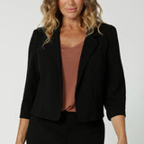 This black workwear cropped jacket exudes sophisticated, modern tailoring, crafted from a luxe Scuba Crepe fabric. The fabric’s soft, textured feel and slight stretch provide both comfort and a flattering fit. 