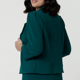 Side view of a great workwear jacket for petite height women. The Benni 3/4 sleeve jacket is worn with tapered leg green workwear pants.
A cropped green jacket , it makes a good workwear suit for women. In sizes 8 to 24, this is a women's jacket  for plus size to petite height women by Australian and New Zealand women's clothing brand, Leina & Fleur.