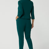 A backview of a great workwear jacket for women over 40, the Benni 3/4 sleeve jacket is worn with tapered leg green workwear pants.
A cropped green jacket , it makes a good workwear suit for women. In sizes 8 to 24, this women's jacket is made in Australia for petite to plus size women. So if you're looking for workwear outfits for curvy women, shop online at Leina & Fleur!  