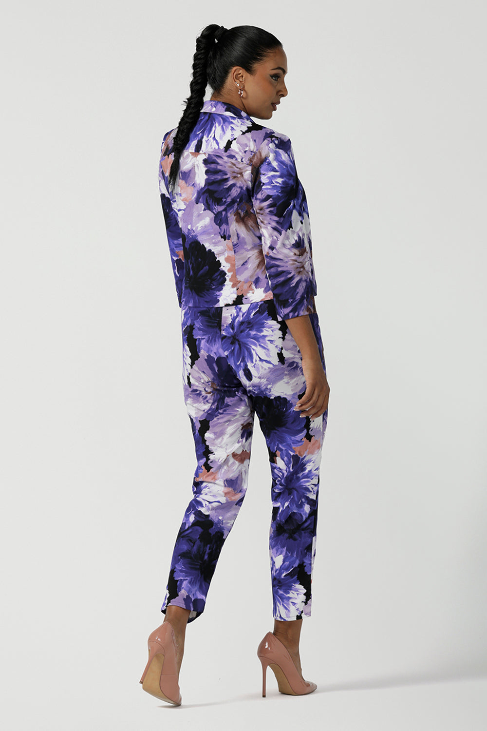 Back view of a size 10 woman wears a Benni Jacket in Jacaranda. With 3/4 sleeves and a floral purple print. Made in Australia for a size inclusive fashion label Leina & Fleur size 8-24.