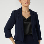 Navy workwear jakcket features open-front design allowing for effortless styling, while the narrow collar and notch lapels add a touch of sharpness to its clean lines. 