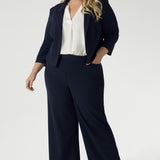 Navy workwear jacket features open-front design allowing for effortless styling, while the narrow collar and notch lapels add a touch of sharpness to its clean lines. 