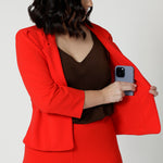 The double-layered tailored front panels add structure, while a hidden phone pocket on the inner left side ensures practicality without compromising the sleek aesthetic. Available in sizes 8-24.