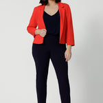 Made from luxe Scuba Crepe, the fabric has a soft, textured feel with just the right amount of stretch, providing both comfort and shape. Petite height model wears classic workwear black pants and top with a pop of colour with the Benni Jacket in Tangerine.