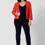 Made from luxe Scuba Crepe, the fabric has a soft, textured feel with just the right amount of stretch, providing both comfort and shape. Petite height model wears classic workwear black pants and top with a pop of colour with the Benni Jacket in Tangerine.