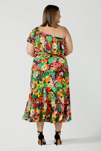 Back view of curvy woman wearing a colourful tiered skirt with off shoulder top. Beautiful Cancun print in multi-colour soft jersey. The perfect statement outfit for the summer season. Designed and made in Australia sizes 8-24.