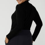 Back view of a size 12 woman wears the Thom top in Black a tie neck top with a V-neckline. Made in comfortable jersey have and made in Australia for women size 8 - 24.