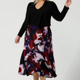 Size 18 woman wears the Berit Maxi skirt in the Fitzroy Print. Styled back with black pumps. Made in Australia for women size 8 - 24.