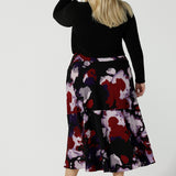 Back view of a size 18 woman wears the Berit Maxi skirt in the Fitzroy Print. Styled back with black pumps. Made in Australia for women size 8 - 24.