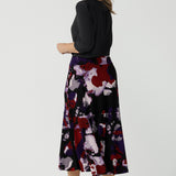 Back view of a size 10 woman wears the Berit Maxi skirt in the Fitzroy Print. Styled back with black pumps. Made in Australia for women size 8 - 24.