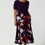 Size 10 woman wears the Berit Maxi skirt in the Fitzroy Print. Styled back with pink pumps and the Amethyst Ziggy Top. Made in Australia for women size 8 - 24. 