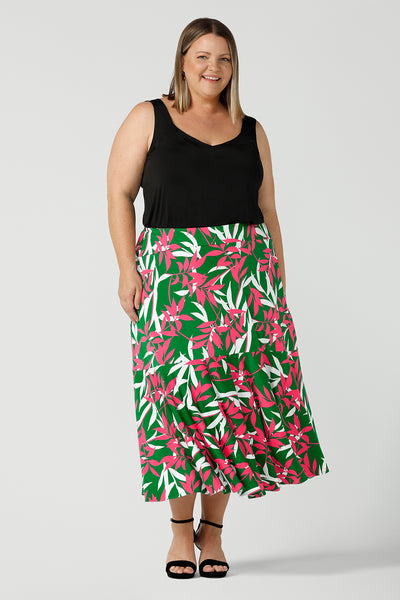 Curvy Woman in a size 18 wears a Verdant Green skirt. Midi jersey skirt with pockets. Styled back with a black cami top. Size 8 - 24. 