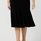 A good workwear skirt for women, this knee-length, pull-on black skirt has pockets, a ruffle hemline and comfort waistband. A great addition to your capsule wardrobe, this black skirt is made by Australian made women's clothing brand, Leina & Fleur. Shop petite to plus size skirts in their online boutique in Australia. 