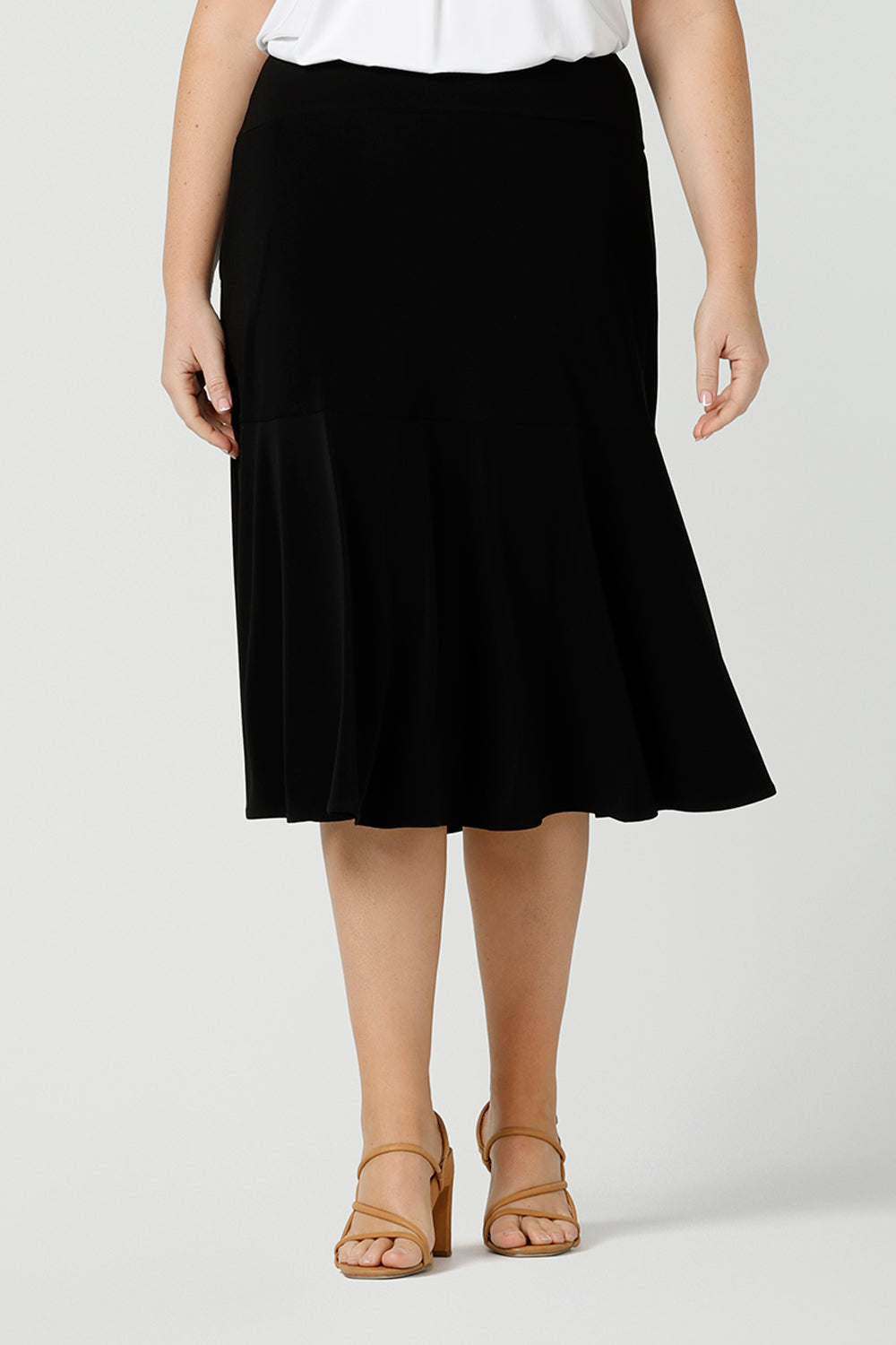 A good workwear skirt for women, this knee-length, pull-on black skirt has pockets, a ruffle hemline and comfort waistband. A great addition to your capsule wardrobe, this black skirt is made by Australian made women's clothing brand, Leina & Fleur. Shop petite to plus size skirts in their online boutique in Australia. 