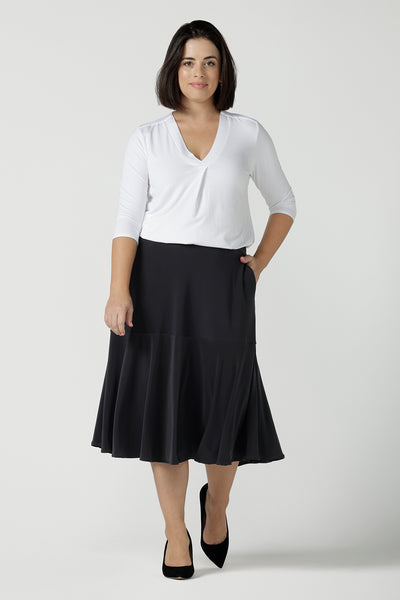 Size 10 Women wears the Berit skirt in Charcoal with pockets and tier hem. A great below knee length skirt perfect for all heights especially petite. Made in Australia for women size 8 - 24.