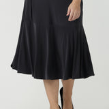 Close up of a size 10 Women wears the Berit skirt in Charcoal with pockets and tier hem. A great below knee length skirt perfect for all heights especially petite. Made in Australia for women size 8 - 24.