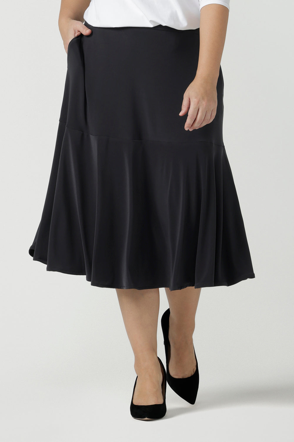 Close up of a size 10 Women wears the Berit skirt in Charcoal with pockets and tier hem. A great below knee length skirt perfect for all heights especially petite. Made in Australia for women size 8 - 24.