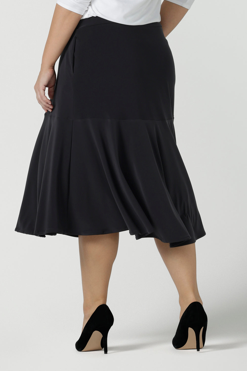 Close up of a size 10 Women wears the Berit skirt in Charcoal with pockets and tier hem. A great below knee length skirt perfect for all heights especially petite. Made in Australia for women size 8 - 24.