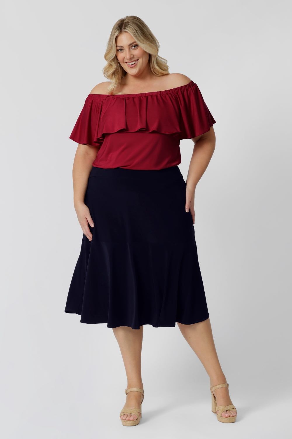 A great example of Australian-made skirts, this navy blue knee-length skirt in comfortable jersey fabric is worn with a fitted short sleeve top in teal. Available from Australian ladies clothing brand, Leina & Fleur, this classic navy skirt is available as petite to plus size office wear in their online boutique.