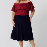 A great example of Australian-made skirts, this navy blue knee-length skirt in comfortable jersey fabric is worn with a fitted short sleeve top in teal. Available from Australian ladies clothing brand, Leina & Fleur, this classic navy skirt is available as petite to plus size office wear in their online boutique.